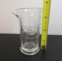 1930’s ENSIGN UK Footed Glass Embossed APOTHECARY MEASURE BEAKER Ounces & Drams