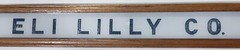 Vintage Eli Lilly Co. Milk White Glass Sign in Frame 6 3/4″ x 4 3/4″ GS00329