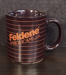 Vintage Feldene Piroxicam 20mg Pharmaceutical Advertising Coffee Mug Brown Promo