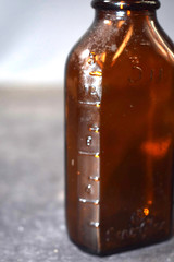 Vintage Medicine Bottle, Amber Glass, Sani-Glass with Black Lid, 4″ Tall
