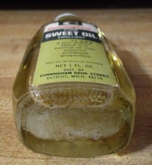 Vtg CUNNINGHAM Sweet Oil Emollient 1oz Glass Mini Glass Bottle 3/4 Full PROP TAG