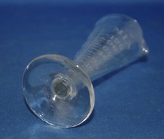 An antique apothecary measuring glass vessel, clear, engraved, fluted