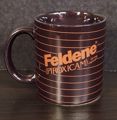 Vintage Feldene Piroxicam 20mg Pharmaceutical Advertising Coffee Mug Brown Promo