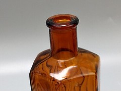 Vintage brown glass chemist bottle with label: Methylated Spirit L.T. Leader