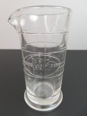 1930’s ENSIGN UK Footed Glass Embossed APOTHECARY MEASURE BEAKER Ounces & Drams