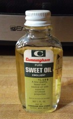 Vtg CUNNINGHAM Sweet Oil Emollient 1oz Glass Mini Glass Bottle 3/4 Full PROP TAG